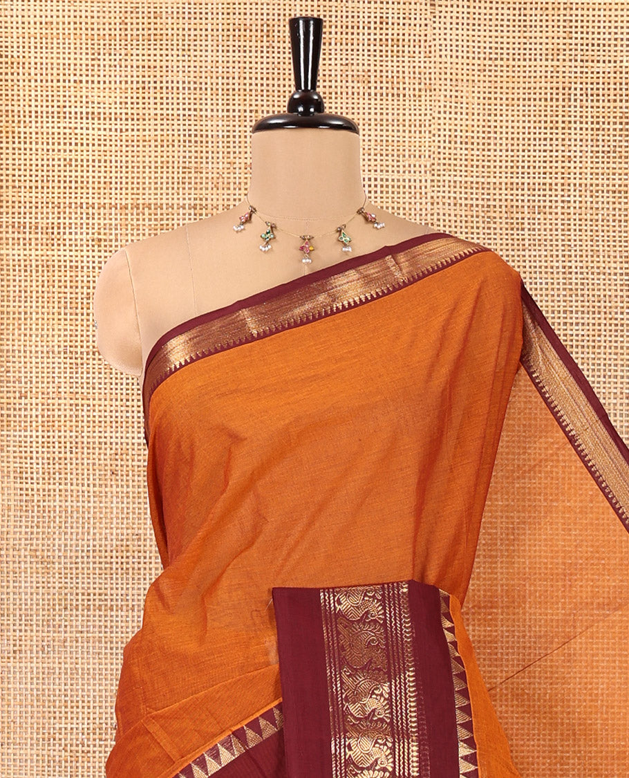 Rust Orange Plain Chettinad Cotton Saree, Complemented by Contrast Rettai Pettu Traditional Zari Border of Temple and Peacock Designs, Striped Pallu, and Paired with a Matching Blouse