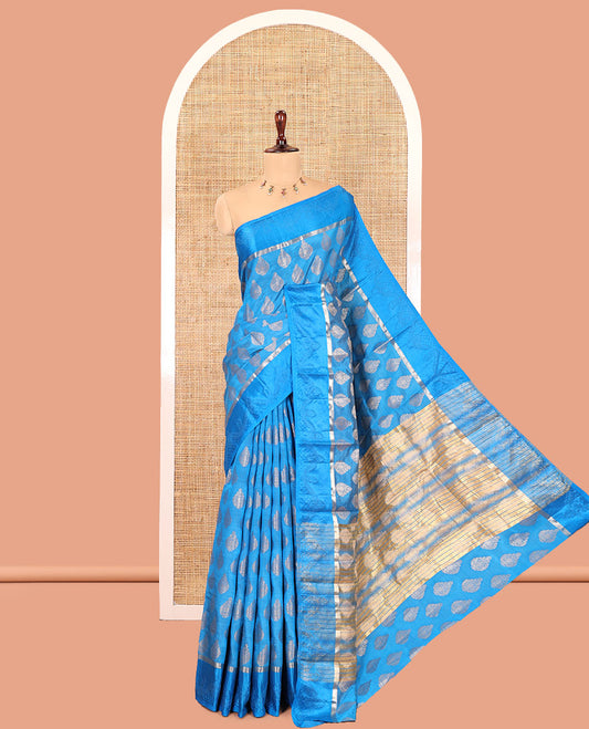 Blue Semi-Tussar Saree, Bedecked with Zari Buttas, a Satin Embossed Border, Gleaming Pallu, and a Matching Blouse