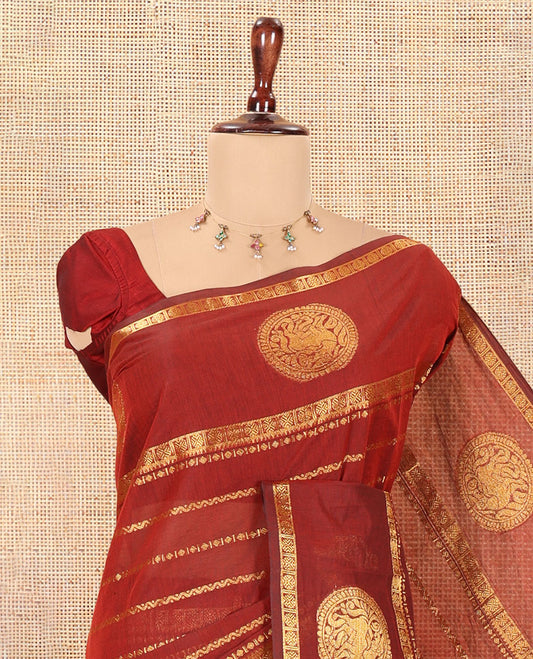 Maroon Chettinad Cotton Saree, Ornamented with Zari Stripes, a Zari Iruthalai Pakshi-Yaali Border, Grand Pallu, and a Matching Blouse
