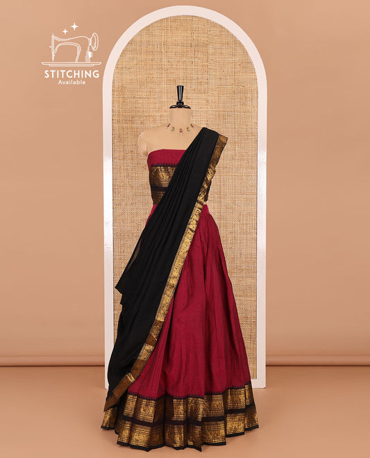 Magenta-black sungudi cotton half-saree, plain with contrast traditional zari varisai pettu bordered skirt, a matching blouse, and a zari bordered dhavani