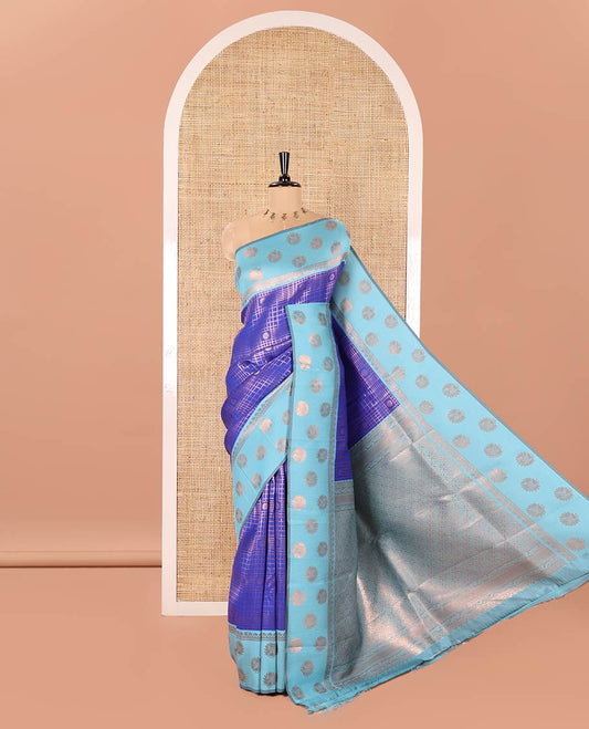 Blue Litchi Saree, Richly Detailed with Zari Buttas and Zari Checked Design on Its Body, Complemented by a Contrast Border Steeped with Peacock Designs, Intricately Designed Pallu, and Paired with a Contrast Blouse