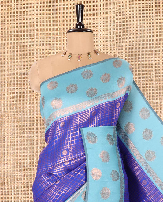 Blue Litchi Saree, Richly Detailed with Zari Buttas and Zari Checked Design on Its Body, Complemented by a Contrast Border Steeped with Peacock Designs, Intricately Designed Pallu, and Paired with a Contrast Blouse