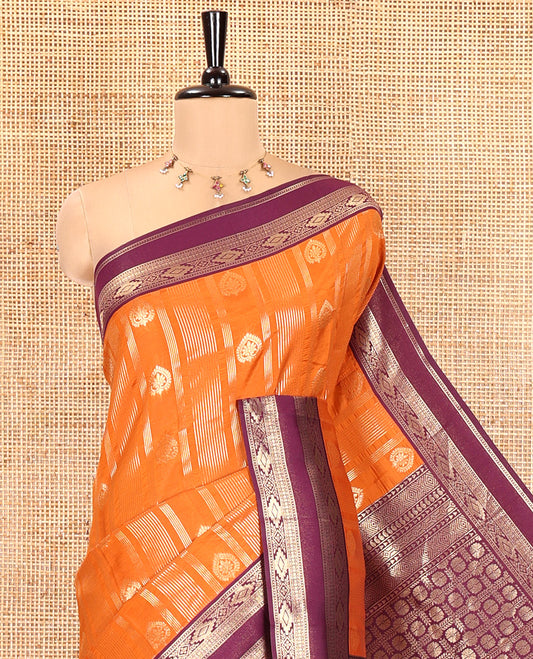 Orange Litchi Saree, Detailed with Vaira Oosi Stripes and Zari Buttas on Its Body, Complemented by a Contrast Rettai Pettu Traditional Zari Design Border, an Intricately Designed Pallu, and Paired with a Contrast Blouse