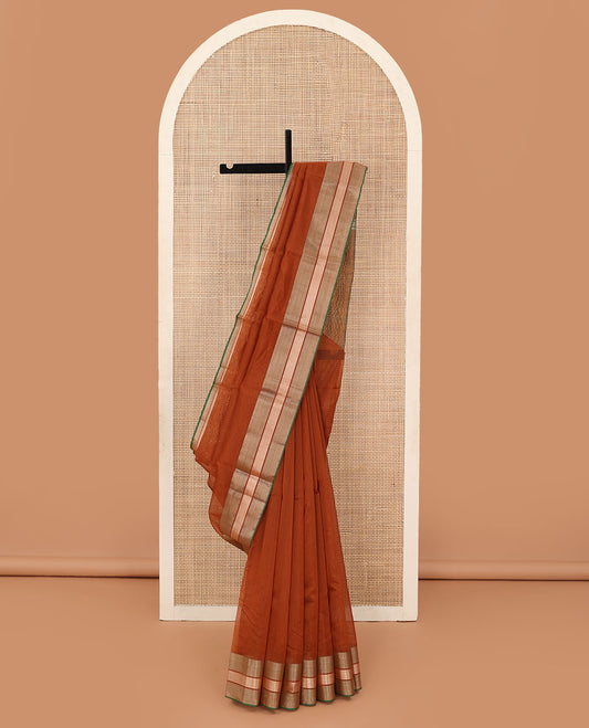 Rust plain silk cotton saree, contrast zari border, and plain pallu