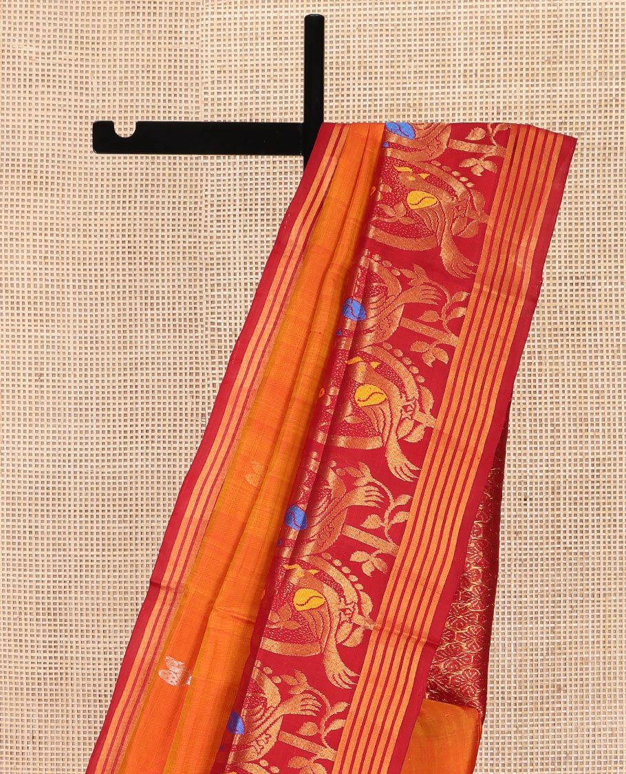 Orange Uppada Silk Saree, Decked Up with Zari Buttas on Its Body, Complemented by a Contrast Border Featuring Floral and Meenakari Bird Designs, Pallu Steeped with Flower Designs, and Paired with a Contrast Blouse