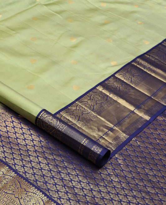 Green zari buttas silk saree, contrast border of rekku, muthu, kamalam, diamond, and mayil kann designs, and jaal pallu