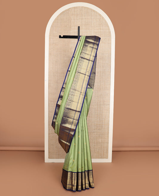 Green zari buttas silk saree, contrast border of rekku, muthu, kamalam, diamond, and mayil kann designs, and jaal pallu