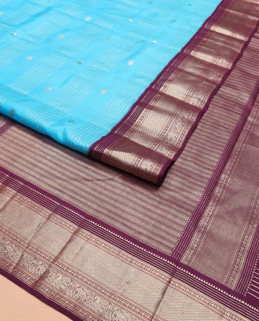 Blue zari design silk saree, contrast border of rekku, muthu, kathir, rudraksham, mayil kann, kuthirai, and yaanai designs, and geometric patterned pallu