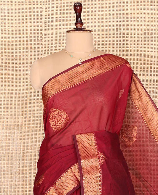 Red Semi-Silk Cotton Saree, Gleamed Up with Flower Pot Zari Buttas on Its Body, Highlighted by Traditional Zari Designs Woven Border, Captivating Contrast Pallu of Intricate Designs, and Paired with a Contrast Blouse
