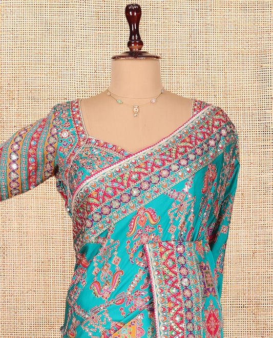 Blue Dola Silk Saree, Adorned with Intricate Designs on Its Body, Highlighted by Mughal-Style Patterns Printed Border, Intricately Designed Pallu, and Paired with a Sweet Heart Elbow Sleeve Blouse