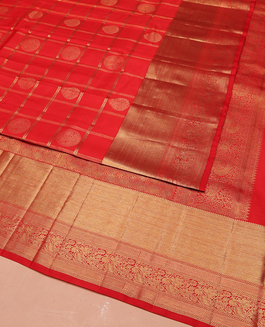 Red Vasundhara Silk Saree Artfully Woven with Zari Butta Enclosed Checks All Over Its Body, Highlighted by Zari Border of Rekku, Mayil Kann, Kathir, and Mayil Designs, a Grand Pallu of Jaal Designs, and Paired with a Matching Blouse