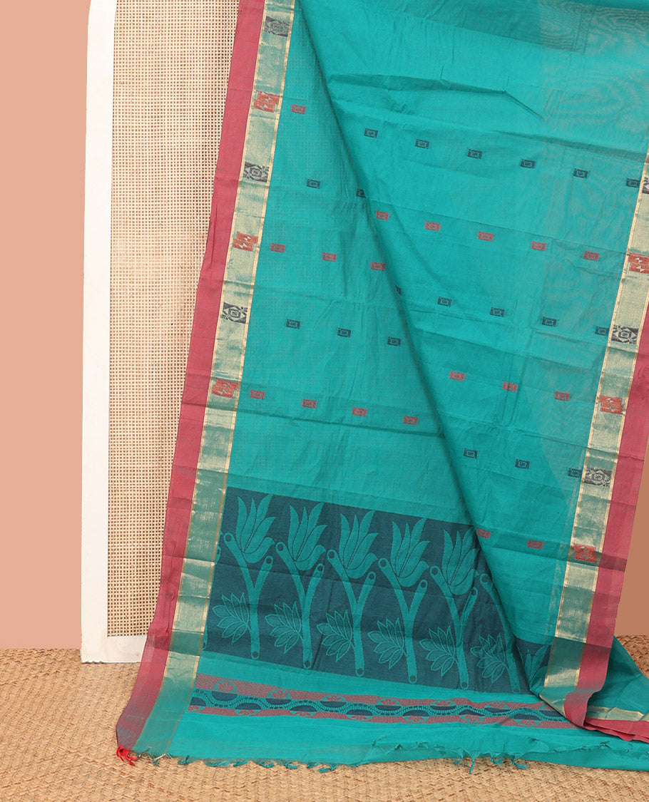 Blue Kanchi Cotton Saree, Decorated with Buttas All Over Its Body, Complemented by a Contrast Border, Pallu Features Floral Designs, and Paired with a Matching Blouse