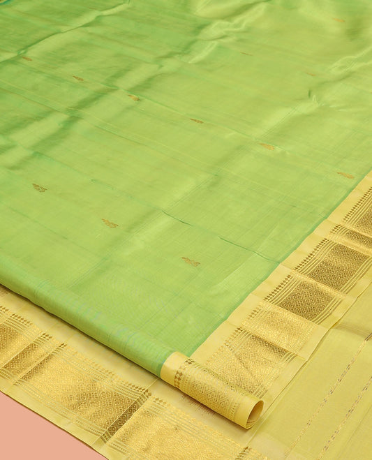 Green Kanchipuram Silk Saree, Woven with Zari Buttas, a Contrast One-Sided Border of Panner Sombu, Banaras, Muthu, and Jaal Designs, a Zari Design Pallu, and No Blouse
