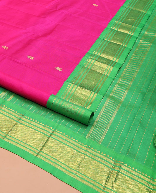 Pink Kanchipuram Silk Saree, Spotlighted with Zari Buttas on Its Body, Complemented by a Contrast One-Sided Korvai Border of Rekku, Banaras, and Mayil Kann Designs, Pallu Steeped with Zari Designs, and Comes Without a Blouse