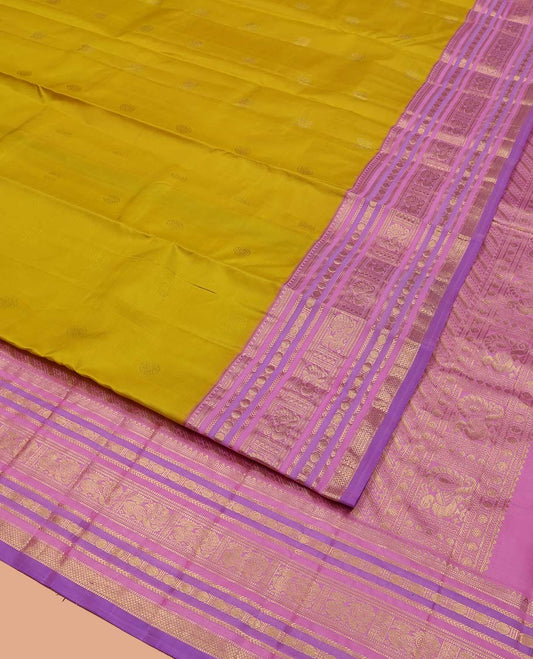 Green Vasundhara Silk Saree, Sparsely Threaded with Zari Buttas All Over Its Body, Complemented by a Contrast Border of Rekku, Muthu, Kathir, Poun, Mayil, and Mayil Kann Designs, Grandly Decked Up Pallu, and Paired with a Contrast Blouse