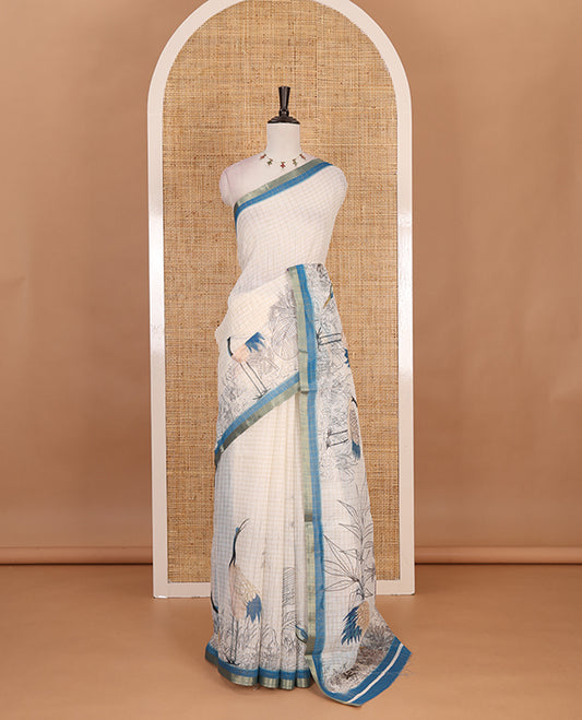 White with blue zari checks linen saree with contrast border and unique designs of pallu along with contrast plain blouse