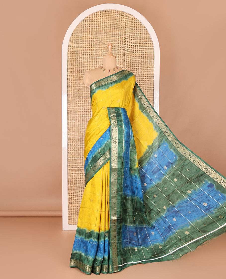 Yellow buttas enclosed checked dola silk saree, contrast shibori print with traditional zari border, buttas enclosed checked pallu, and a contrast buttas enclosed checked blouse