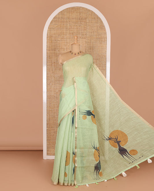 Green sun and deer silhouette printed linen cotton saree, gold zari piping border, printed pallu, and a matching stripes printed blouse