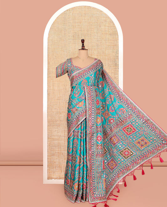Blue Dola Silk Saree, Adorned with Intricate Designs on Its Body, Highlighted by Mughal-Style Patterns Printed Border, Intricately Designed Pallu, and Paired with a Sweet Heart Elbow Sleeve Blouse