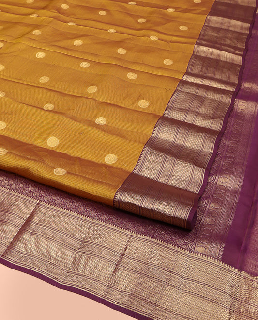 Mustard Vasundhara Lite Silk Mix Saree, Subtly Woven with Zari Buttas, Complemented by a Contrast Border of Rekku, Muthu, Vanki, and Mayil Kann Designs, Majestically Detailed Pallu of Ogee Patterns, and Paired with a Contrast Blouse