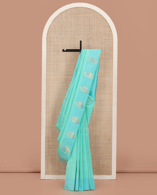 Turquoise Kanchipuram Silk Saree Woven with Zari Buttas, Subtly Sprakled Contrasting Border of Manga Designs, Zari Motifs Woven Pallu, and Paired with a Contrast Blouse