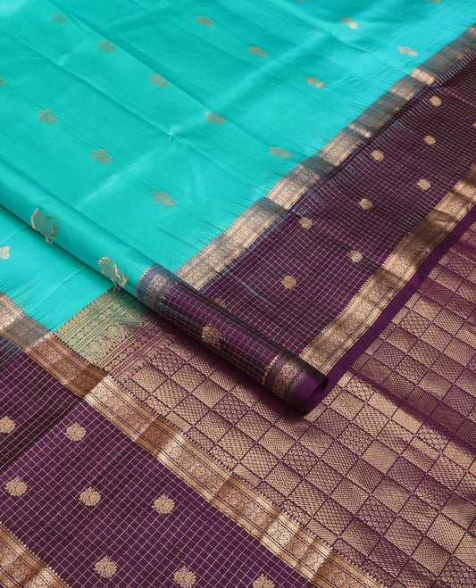 Blue zari buttas soft silk saree, contrast border of thilakam,jada nagam,mayil kann, zari checked & mayil designs & geometric patterned pallu