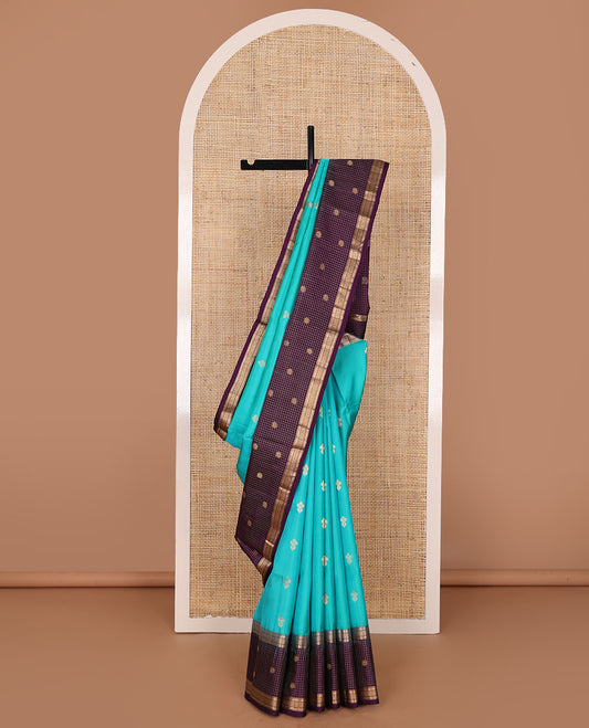 Blue zari buttas soft silk saree, contrast border of thilakam,jada nagam,mayil kann, zari checked & mayil designs & geometric patterned pallu