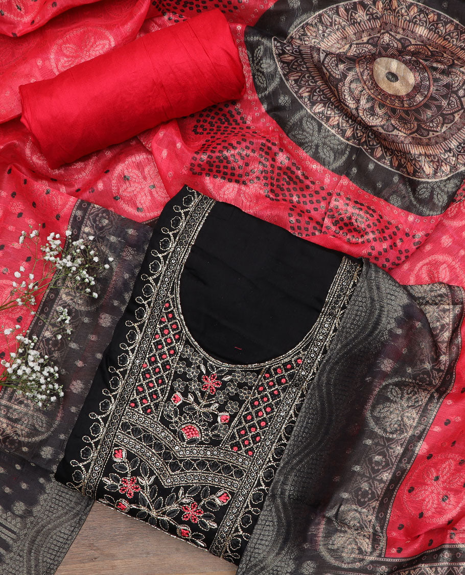 Black material churidar set, neck embroidered top, contrast plain bottom, and a contrast dupatta of bandhani dots, and chakram motifs