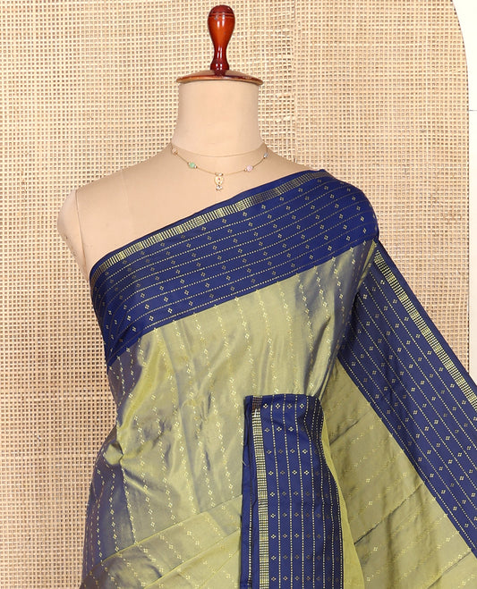 Green Aarani Silk Saree, Ornamented with Zari Stripes All Over Its Body, Complemented by a Contrast Zari Stripes and Buttas Woven Border, Pallu of Stripes, and Paired with a Matching Blouse
