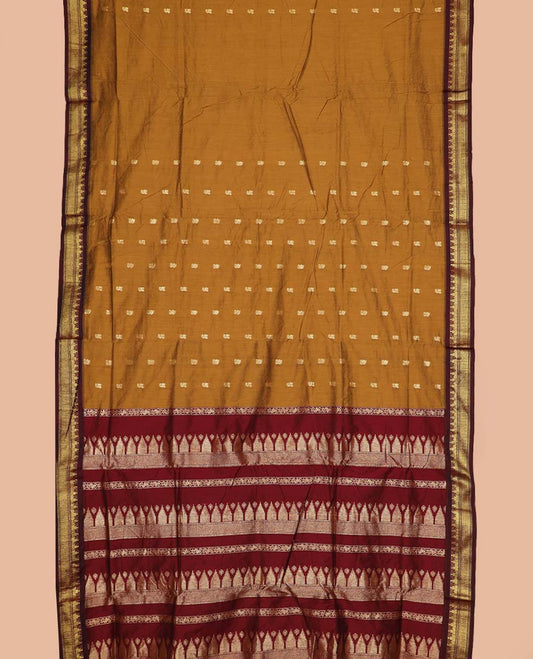 Mustard buttas nine-yard cotton saree, contrast traditional zari border, and pallu steeped with traditional motifs
