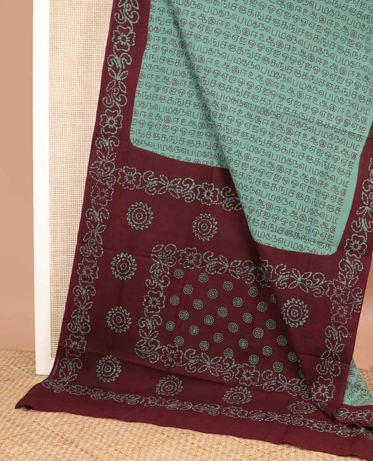 Green Tamil letters printed sungudi cotton saree, contrast batik printed border, and batik printed pallu
