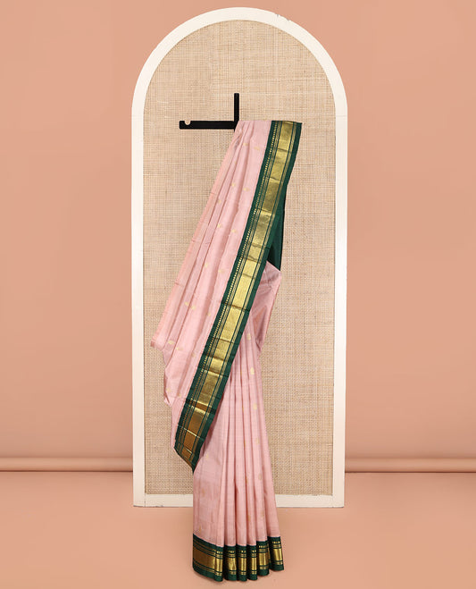 Peach Kanchipuram Silk Saree, Subtly Sparkled with Zari Buttas on Its Body, Complemented by a Contrast One-Sided Korvai Border of Panner Sombu, Banaras, Muthu, and Mayil Kann Designs, Pallu Steeped with Zari Designs, and Comes Without a Blouse
