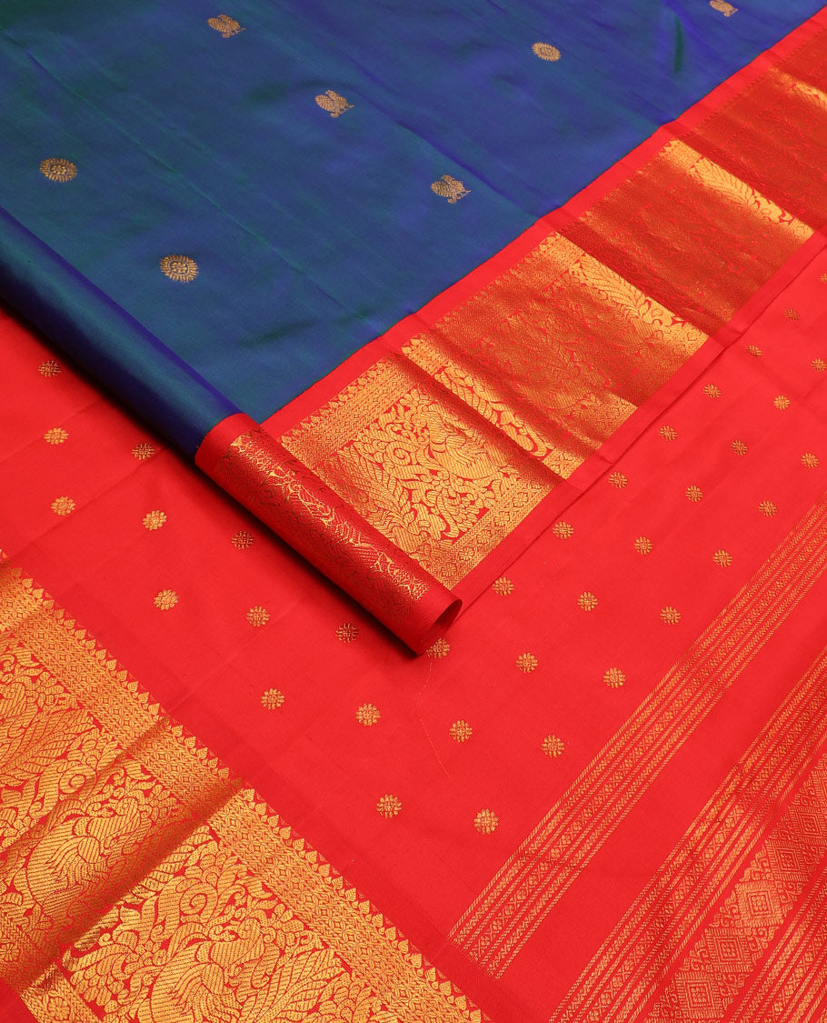 Blue mayil chakram buttas Kanchipuram silk saree, contrast korvai border of thilakam mokku, cross kamalam, and mayil designs, and intricate pallu