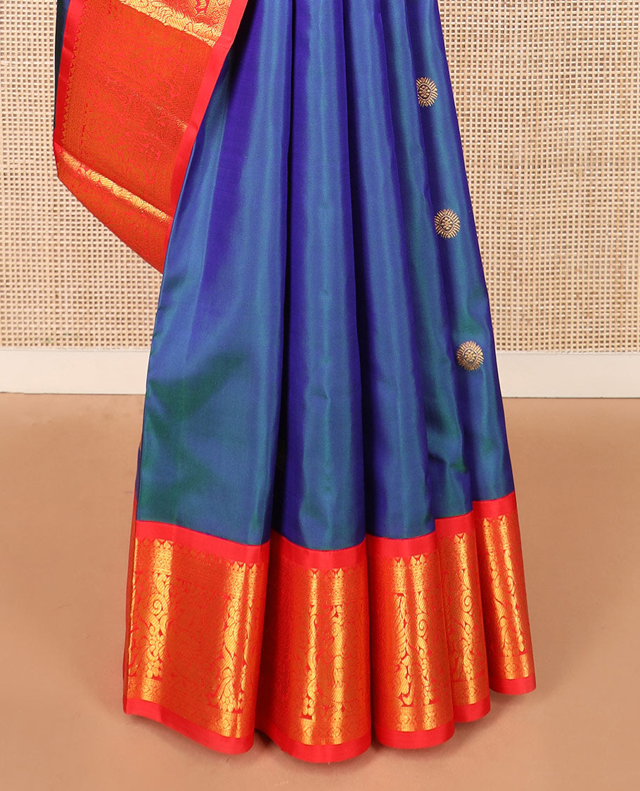 Blue mayil chakram buttas Kanchipuram silk saree, contrast korvai border of thilakam mokku, cross kamalam, and mayil designs, and intricate pallu