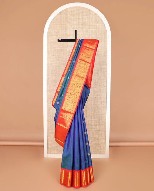 Blue mayil chakram buttas Kanchipuram silk saree, contrast korvai border of thilakam mokku, cross kamalam, and mayil designs, and intricate pallu