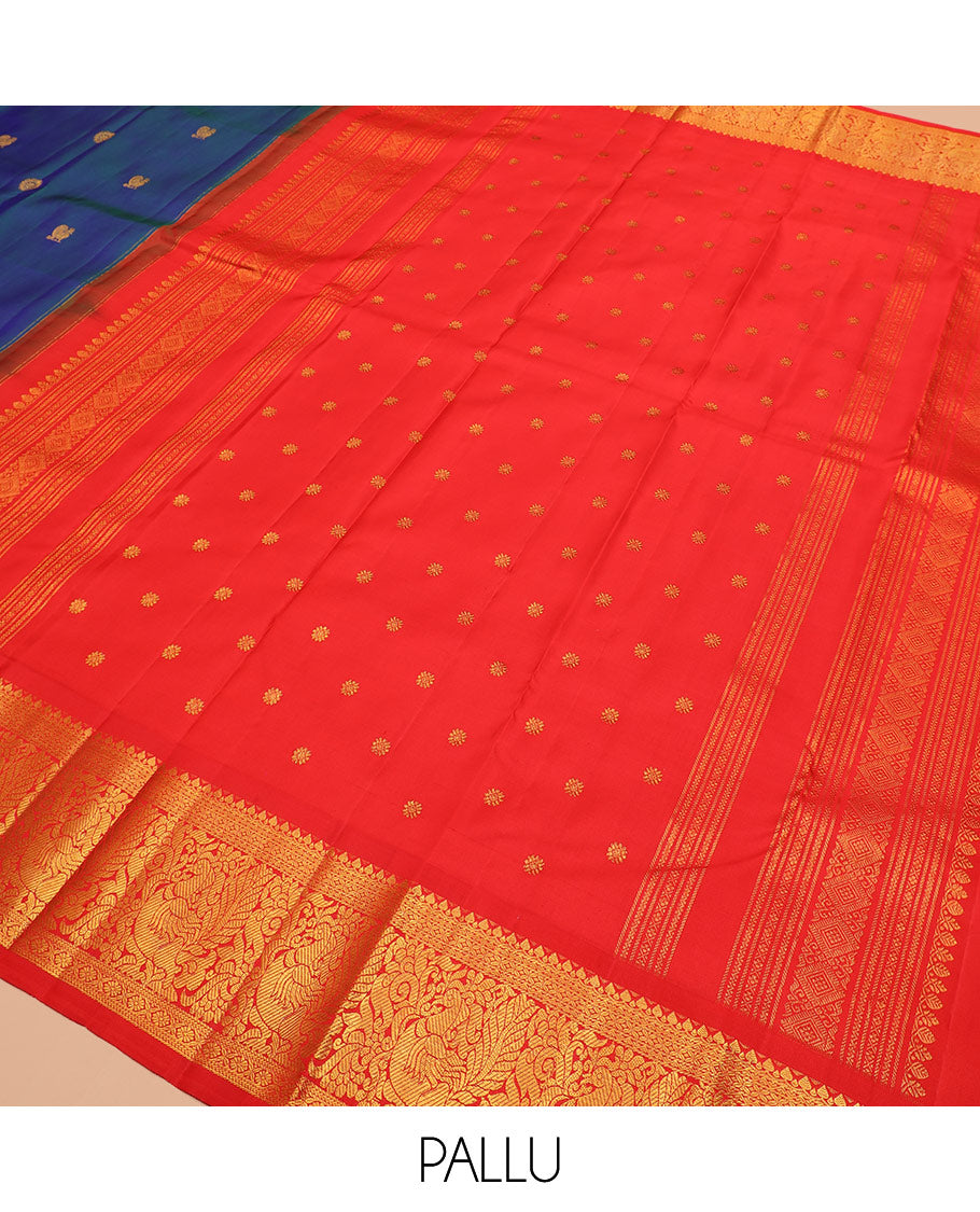 Blue mayil chakram buttas Kanchipuram silk saree, contrast korvai border of thilakam mokku, cross kamalam, and mayil designs, and intricate pallu