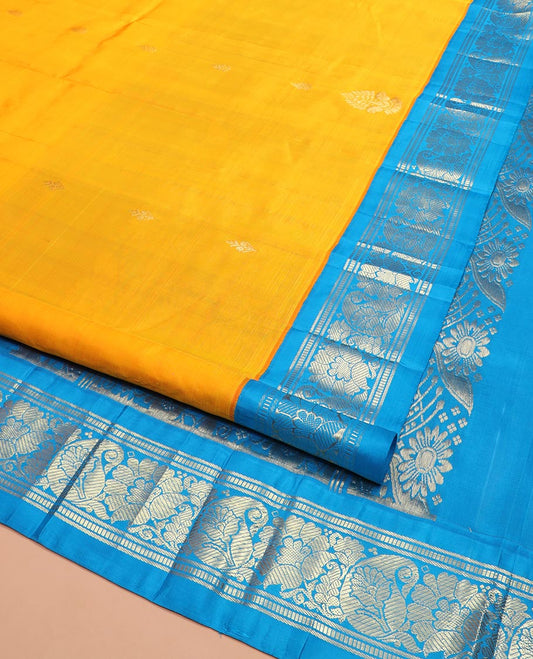 Yellow Kanchipuram Silk Saree Sparsely Sparkled with Zari Buttas All Over Its Body, Complemented by a Contrast One-Sided Korvai Border of Banaras, Muthu, Manga, and Floral Designs, Pallu of Floral Designs, and Comes Without a Blouse