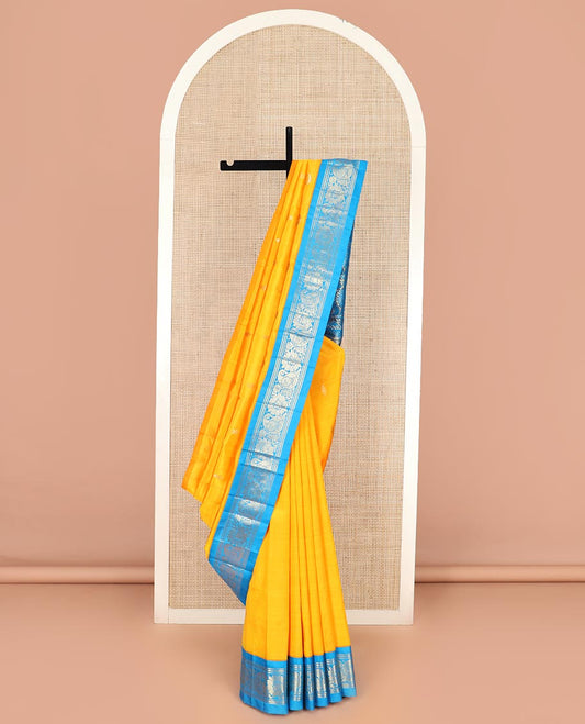 Yellow Kanchipuram Silk Saree Sparsely Sparkled with Zari Buttas All Over Its Body, Complemented by a Contrast One-Sided Korvai Border of Banaras, Muthu, Manga, and Floral Designs, Pallu of Floral Designs, and Comes Without a Blouse