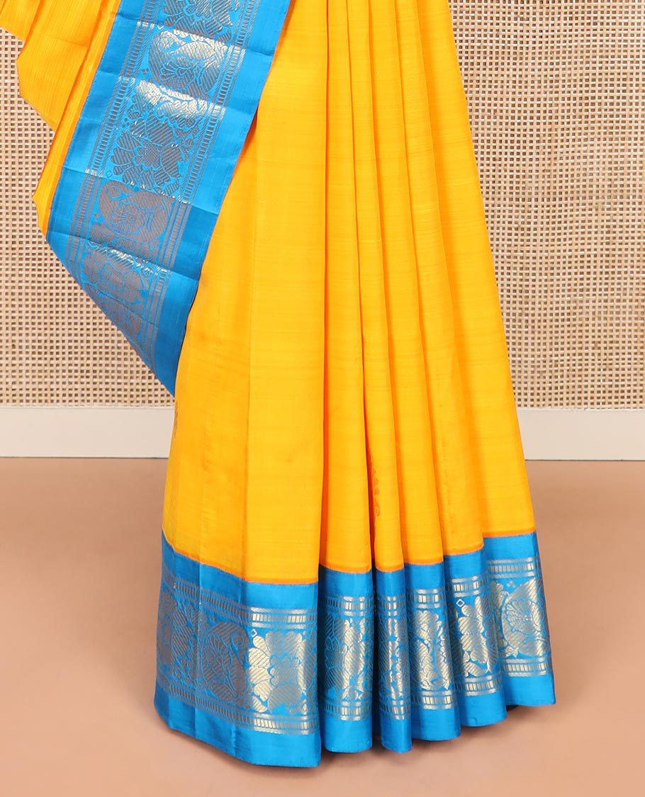Yellow Kanchipuram Silk Saree Sparsely Sparkled with Zari Buttas All Over Its Body, Complemented by a Contrast One-Sided Korvai Border of Banaras, Muthu, Manga, and Floral Designs, Pallu of Floral Designs, and Comes Without a Blouse