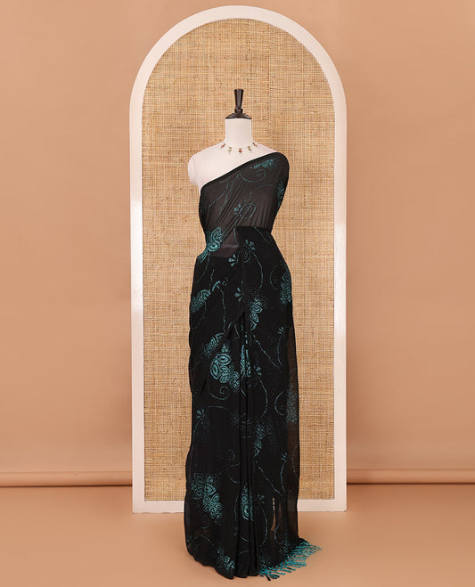 Borderless black 60 gm georgette saree features floral vine designs blue glitter embroidery work, contrast plain blouse