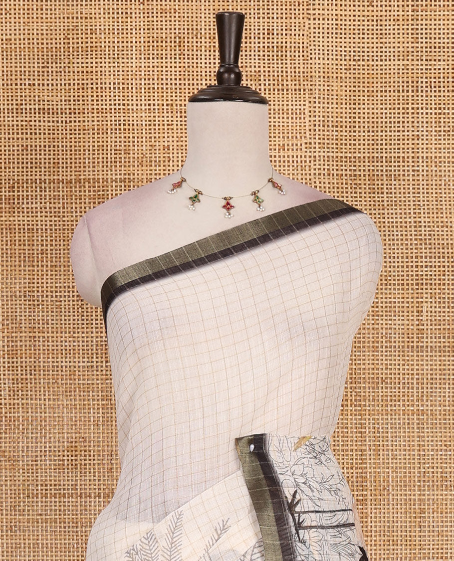 White with green zari checks linen saree with contrast border and unique designs of pallu along with contrast plain blouse