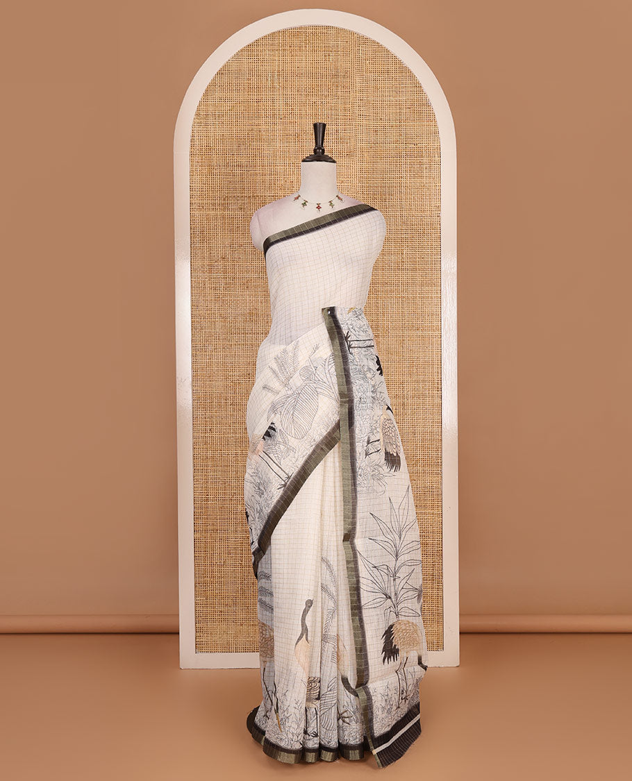 White with green zari checks linen saree with contrast border and unique designs of pallu along with contrast plain blouse