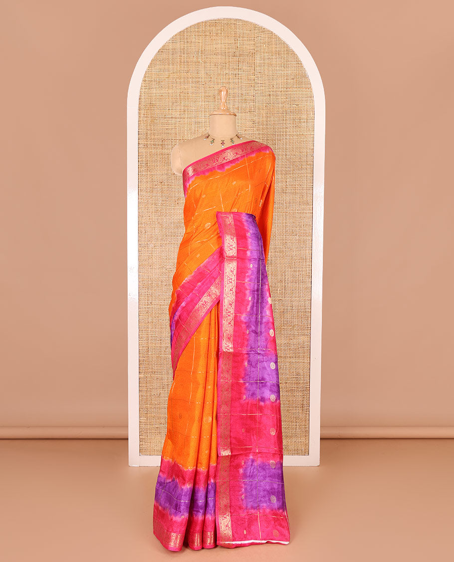 Orange buttas enclosed checked dola silk saree, contrast shibori print with traditional zari border, buttas enclosed checked pallu, and a contrast buttas enclosed checked blouse