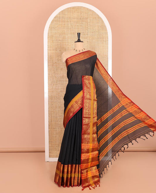 Black Plain Mercerised Cotton Saree Artfully Detailed with a Contrasting Rettai Pettu Border Featuring Peacock Motifs in Zari, a Subtly Striped Pallu, and a Matching Blouse