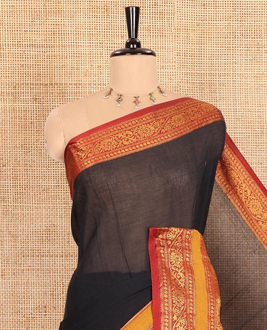 Black Plain Mercerised Cotton Saree Artfully Detailed with a Contrasting Rettai Pettu Border Featuring Peacock Motifs in Zari, a Subtly Striped Pallu, and a Matching Blouse
