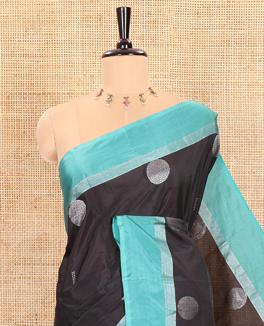 Black Semi-Soft Silk Saree Featuring Round Silver Zari Buttas Woven Across Its Body, Complemented by a Contrast Zari Design Border, Subtly Made Self-Pallu, and a Matching Blouse
