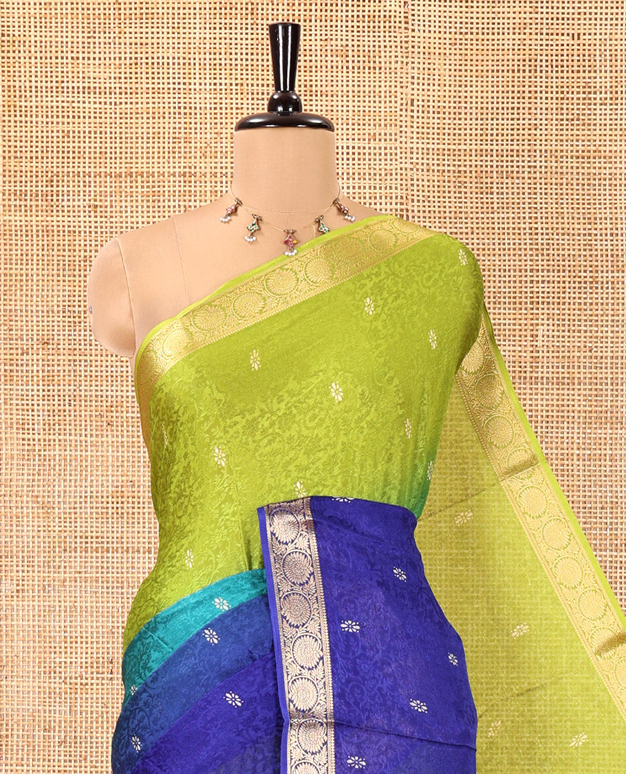 Green and Royal Blue Candy Chiffon Saree, Featuring Floral Vine Embossed, Buttas, and Ombre-Style Dyed on Its Body, Highlighted by Floral Creeper Zari Border, Intricately Designed Pallu, and Paired with a Contrast Blouse