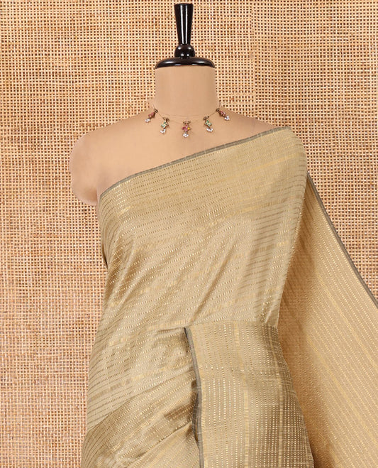 Borderless Chikku Semi-Raw Silk Saree, Subtly Sparkled with Muthu Stripes on Its Body, Complemented by a Contrast Zari Striped Pallu, and Paired with a Contrast Blouse