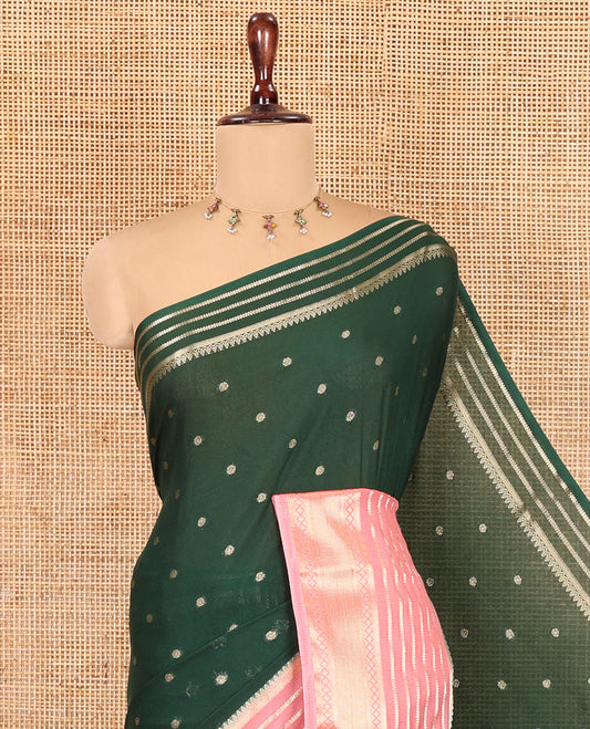 Green Art Crepe Saree Features Zari Buttas, Complemented by Contrast Traditional Zari Border, Zari Striped Pallu, and a Contrast Blouse