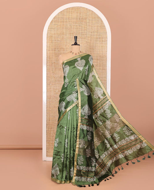 Forest green tree motifs discharge printed banana pith saree, zari piping border, floral printed pallu, and a tree discharge printed blouse